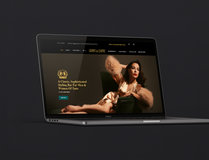 Luxury salon website design for Grant & Dunne Styling Bar displayed on a laptop, featuring an elegant model in a gold dress and fur wrap against a dark, sophisticated background.